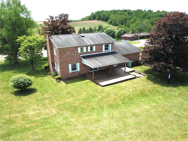1194 Butler Rd, East Franklin Twp, PA 16262 - rear view of house featuring brick siding, a chimney, a deck, and a yard