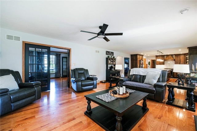 living area featuring a ceiling fan, visible vents, recessed lighting, and light wood-style floors