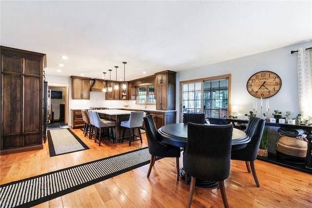 dining area with light wood-type flooring and recessed lighting
