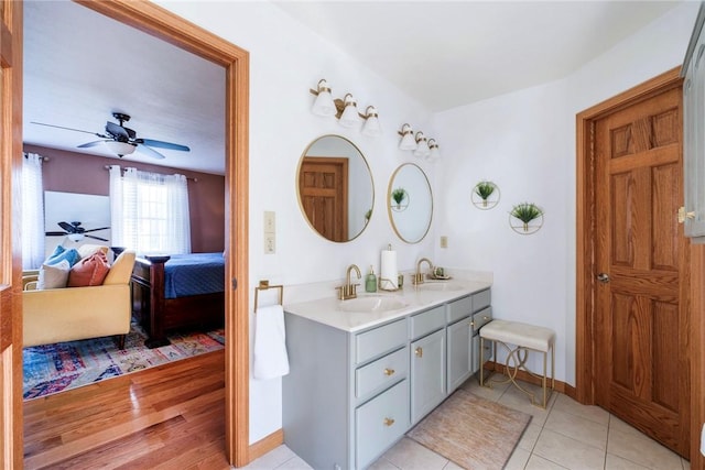 ensuite bathroom with ensuite bathroom, a sink, ceiling fan, and double vanity