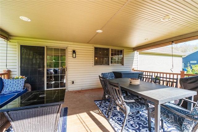 wooden terrace featuring outdoor dining area