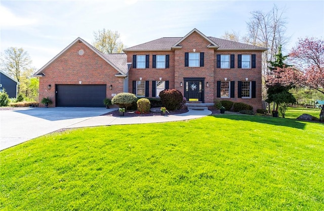 colonial home with concrete driveway, brick siding, a garage, and a front lawn