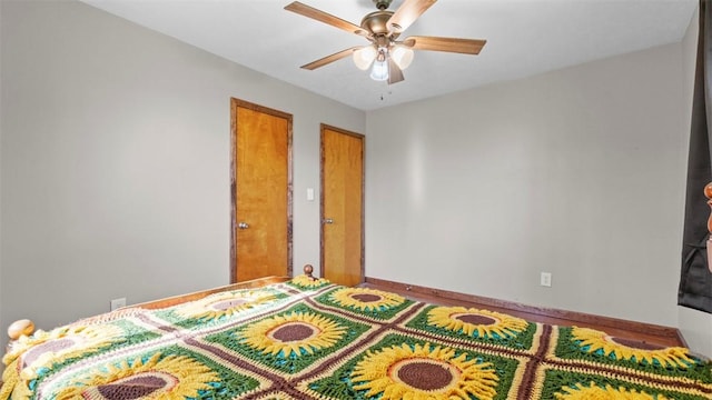 bedroom featuring baseboards and ceiling fan