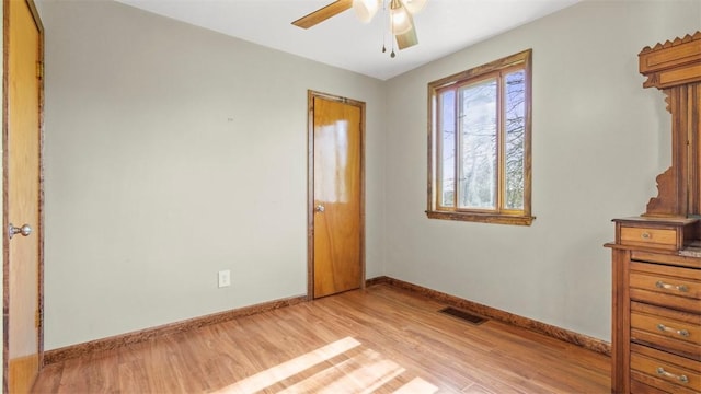 unfurnished bedroom with a ceiling fan, baseboards, visible vents, and light wood-type flooring