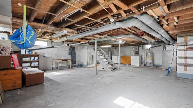 below grade area with stairs, heating unit, washer / dryer, and gas water heater