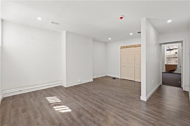 interior space featuring recessed lighting, baseboards, and wood finished floors