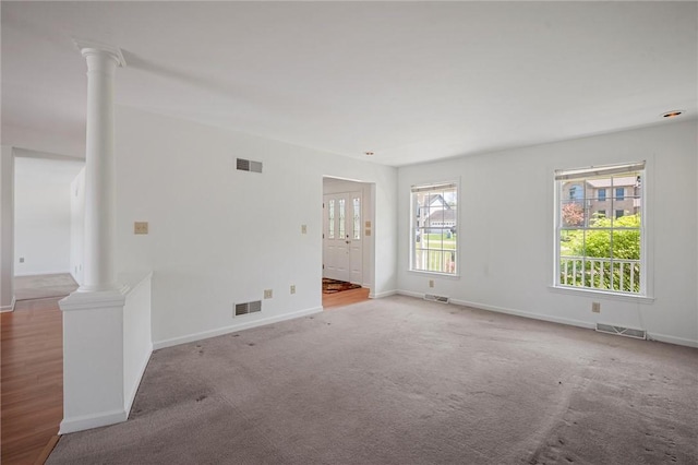 empty room featuring baseboards and visible vents