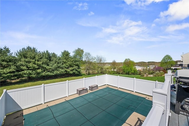 view of swimming pool with fence