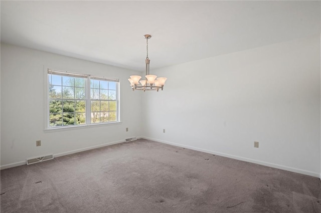unfurnished room featuring baseboards, a chandelier, and visible vents