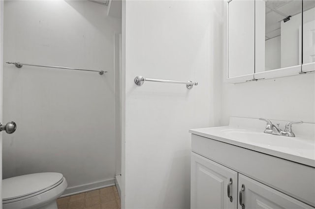 bathroom with vanity, baseboards, and toilet