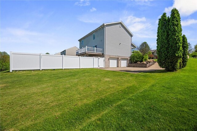 view of yard featuring a garage and fence