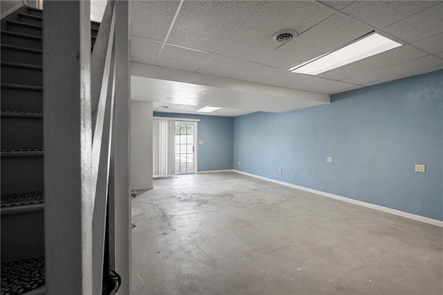 basement featuring stairway, baseboards, and visible vents