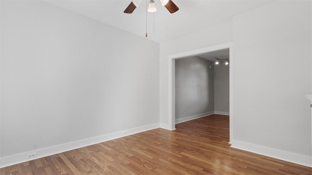 unfurnished room featuring a ceiling fan, baseboards, and light wood-style flooring
