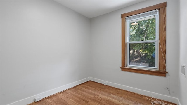 unfurnished room featuring baseboards and light wood-style flooring