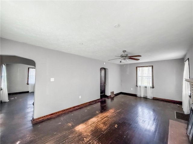 2103 Oriole Dr, Hopewell Twp Bea, PA 15001 - unfurnished living room featuring baseboards, arched walkways, ceiling fan, and wood finished floors