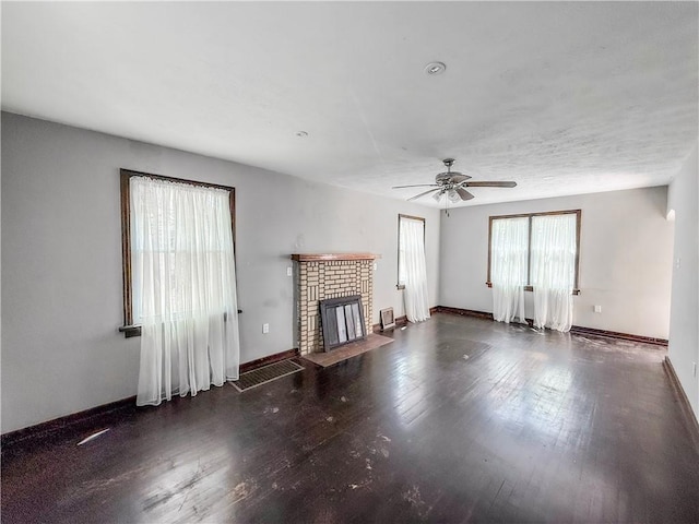 2103 Oriole Dr, Hopewell Twp Bea, PA 15001 - unfurnished living room with a brick fireplace, a ceiling fan, baseboards, and wood finished floors
