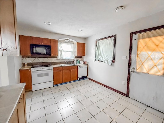 2103 Oriole Dr, Hopewell Twp Bea, PA 15001 - kitchen featuring brown cabinets, a sink, white appliances, light countertops, and tasteful backsplash