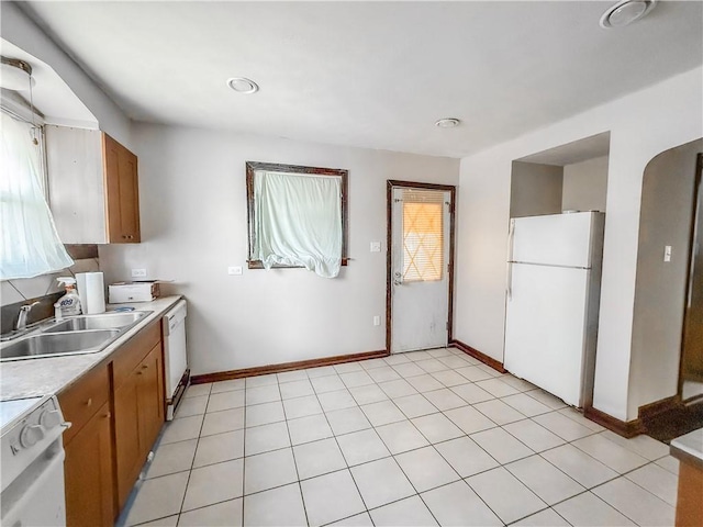 2103 Oriole Dr, Hopewell Twp Bea, PA 15001 - kitchen featuring brown cabinets, a sink, white appliances, light countertops, and baseboards