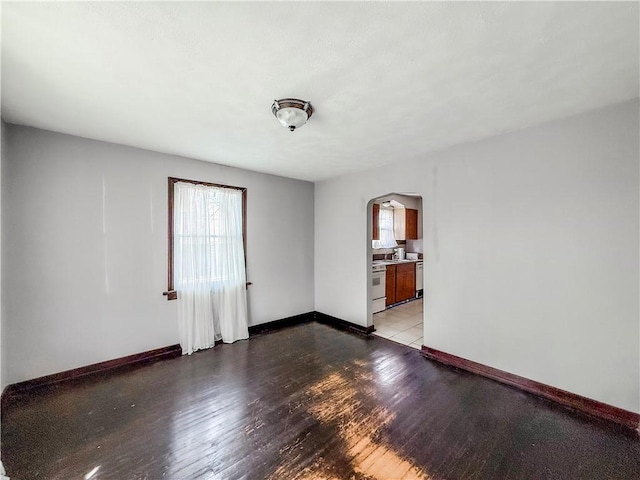 2103 Oriole Dr, Hopewell Twp Bea, PA 15001 - empty room with arched walkways, baseboards, and light wood-type flooring