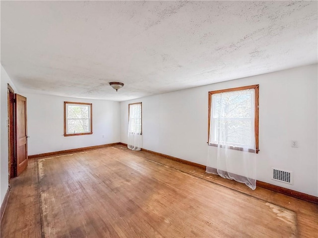2103 Oriole Dr, Hopewell Twp Bea, PA 15001 - unfurnished room with baseboards, light wood finished floors, a textured ceiling, and visible vents
