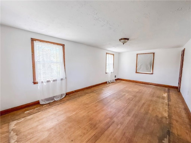 2103 Oriole Dr, Hopewell Twp Bea, PA 15001 - unfurnished room with baseboards, a textured ceiling, and light wood-style flooring