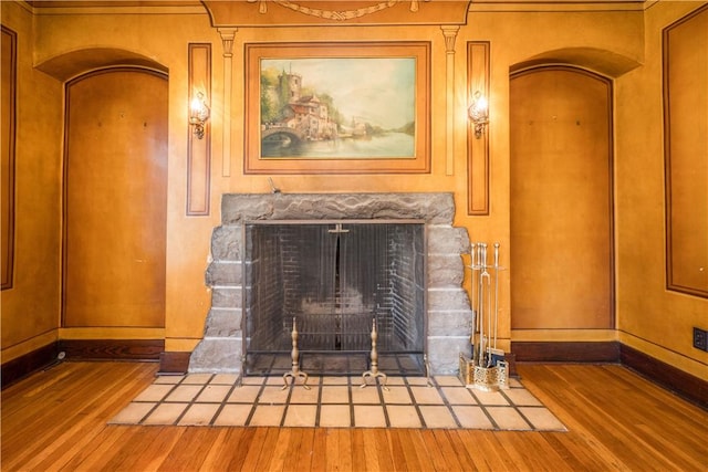 details featuring baseboards, wood finished floors, and a high end fireplace