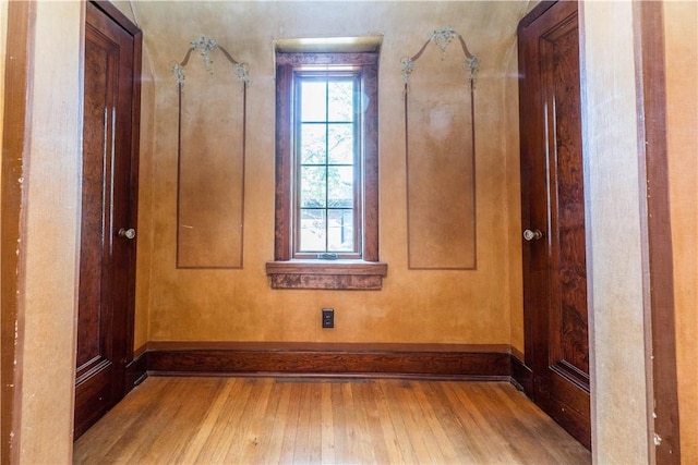 empty room featuring baseboards and wood finished floors