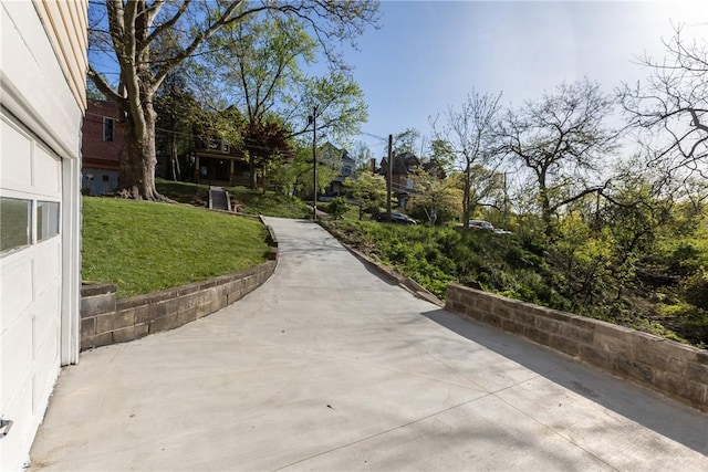 view of home's community featuring a lawn, a residential view, and a patio