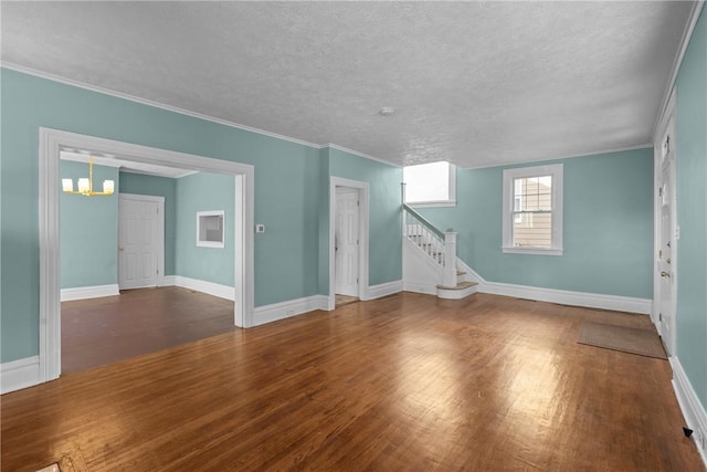interior space with baseboards, stairs, wood finished floors, and a notable chandelier