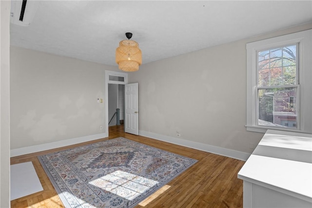 empty room with baseboards and wood finished floors