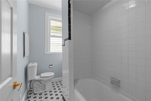 full bath with baseboards, tile patterned floors, toilet, and shower / tub combination