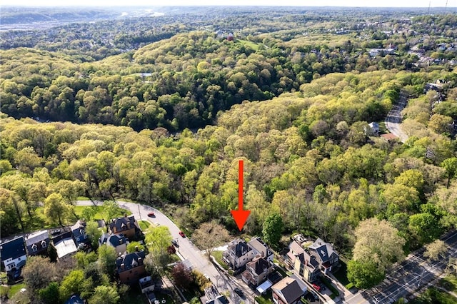 birds eye view of property with a view of trees