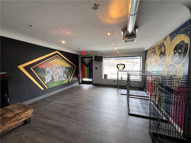 recreation room featuring baseboards and wood finished floors