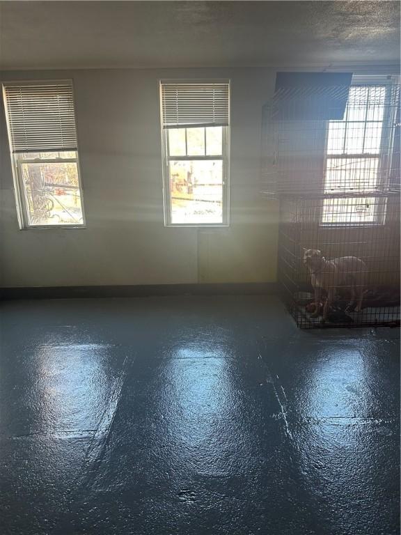 spare room featuring finished concrete flooring