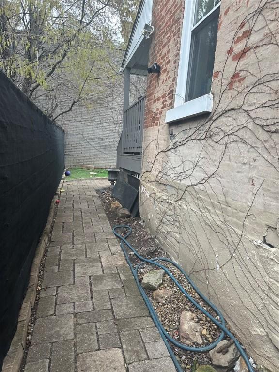 view of side of home featuring brick siding