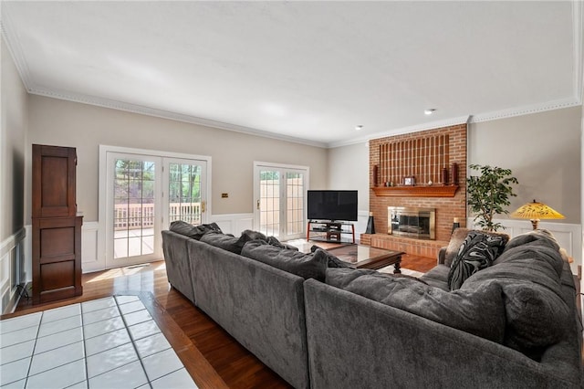1641 Blackburn Heights Dr, Franklin Park, PA 15143 - living area featuring ornamental molding, wainscoting, a brick fireplace, wood finished floors, and a decorative wall