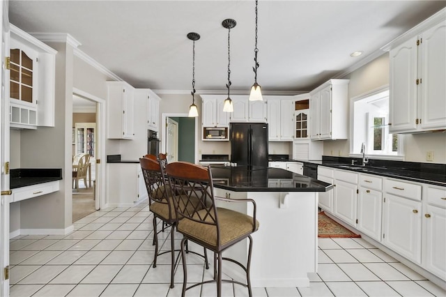 1641 Blackburn Heights Dr, Franklin Park, PA 15143 - kitchen featuring white cabinets, a breakfast bar, a sink, a center island, and black appliances