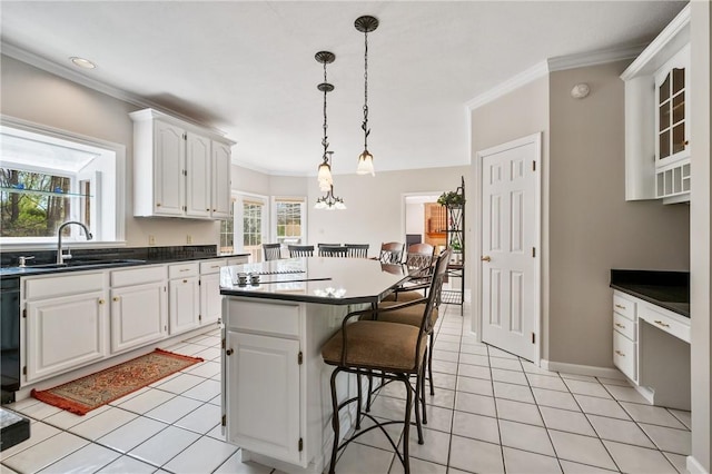 1641 Blackburn Heights Dr, Franklin Park, PA 15143 - kitchen featuring a sink, ornamental molding, white cabinets, and a kitchen breakfast bar