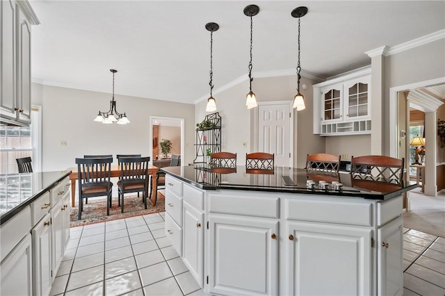 1641 Blackburn Heights Dr, Franklin Park, PA 15143 - kitchen featuring ornamental molding, a kitchen island, light tile patterned flooring, dark countertops, and white cabinets