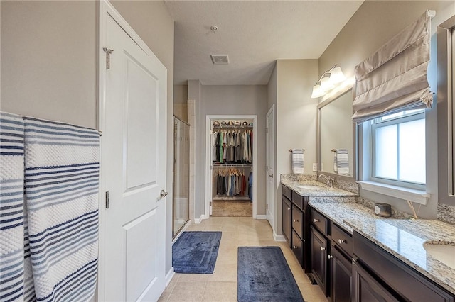 2008 Connecticut Ln, Franklin Park, PA 15143 - full bathroom with a shower stall, vanity, tile patterned flooring, a walk in closet, and baseboards