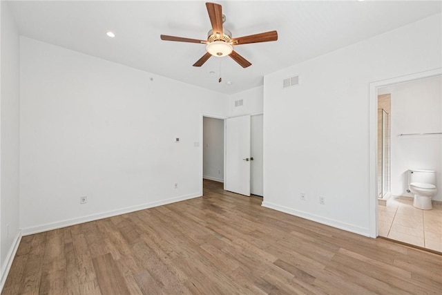 5541 Butler St, Lawrenceville, PA 15201 - unfurnished bedroom with baseboards, ensuite bath, wood finished floors, and visible vents