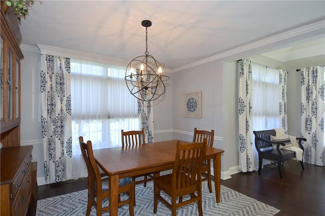 dining space featuring dark wood-type flooring, ornamental molding, baseboards, and a chandelier