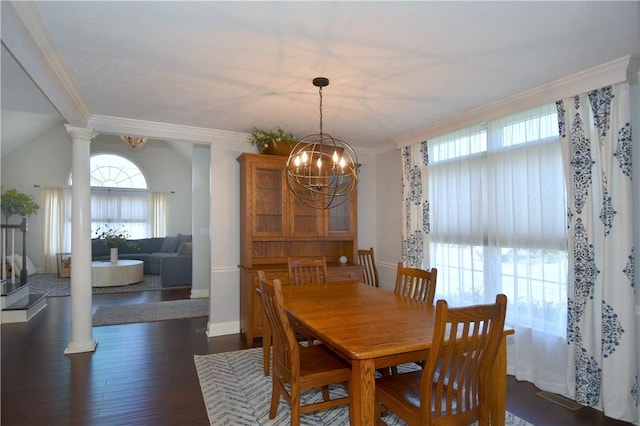 dining room with plenty of natural light, ornamental molding, dark wood-type flooring, and a chandelier
