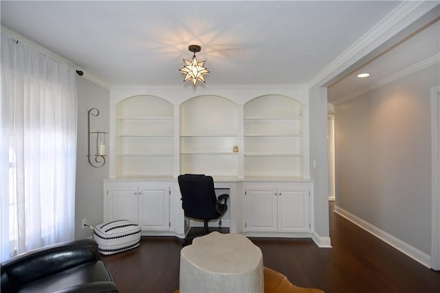 office area featuring baseboards, dark wood finished floors, built in features, and built in desk