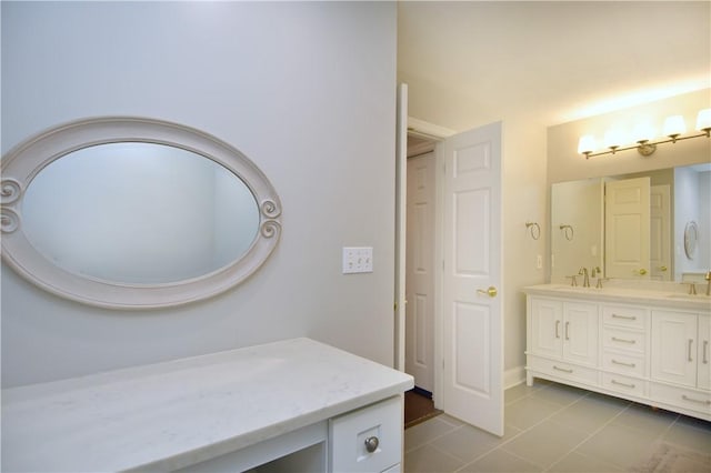 bathroom featuring double vanity, tile patterned floors, and a sink