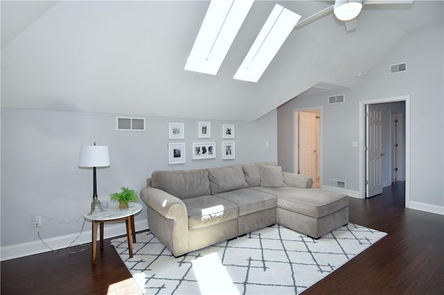 living room with visible vents, lofted ceiling with skylight, and wood finished floors