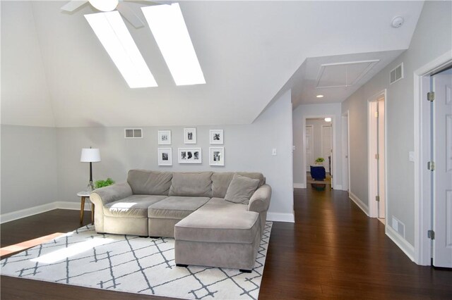 living room featuring visible vents, attic access, and wood finished floors