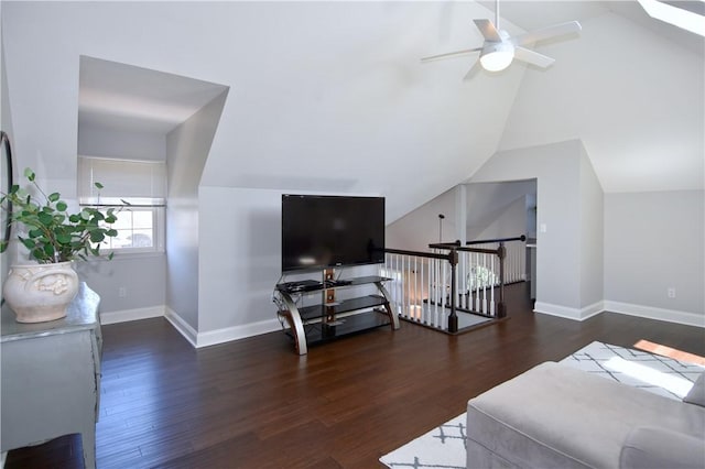 interior space featuring baseboards, vaulted ceiling, and wood finished floors