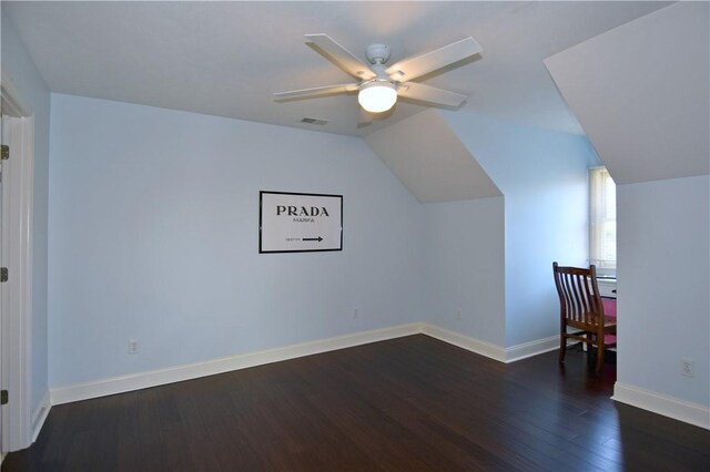bonus room featuring dark wood-style flooring, ceiling fan, visible vents, baseboards, and vaulted ceiling