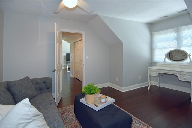 living area with baseboards, ceiling fan, wood finished floors, and visible vents